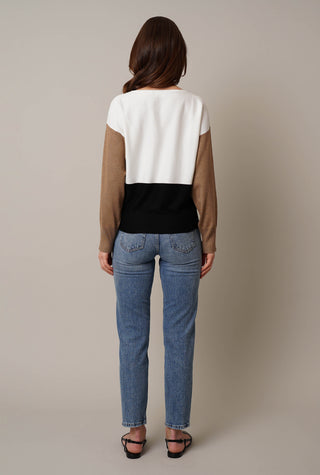 Model is wearing the color block dolman by Cyrus in Bone/Black/Latte Macaroon