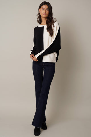 The model is wearing a Cyrus Color Block Dolman Sweater.