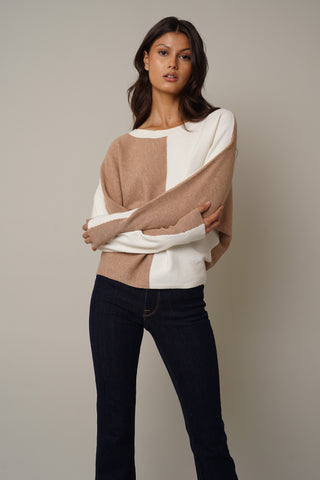 The model is wearing a Cyrus Color Block Dolman Sweater.