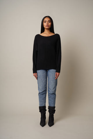 Model is wearing the Ribbed Dolman Pullover in Black.
