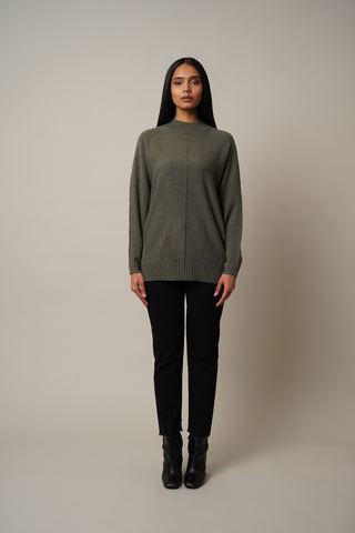 Model is wearing the Dolman Sleeve Mock Neck Pullover in Burnt Olive Heather.
