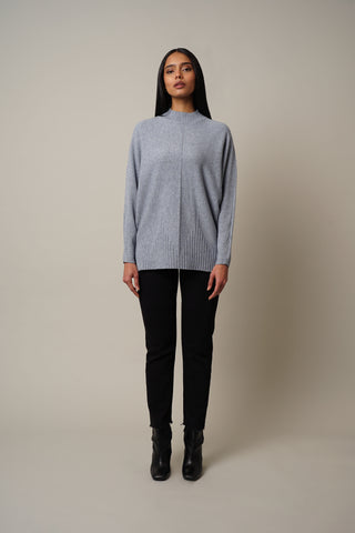 Model is wearing the Dolman Sleeve Mock Neck Pullover in Lily Blue.