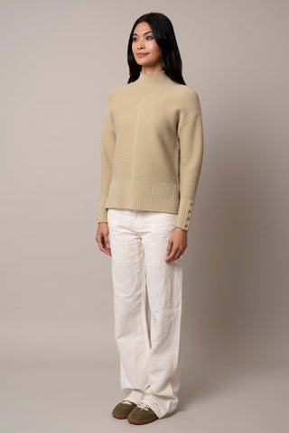 Model is wearing the mock-neck-pullover-with-button-cuff in Pale Olive