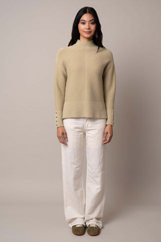 Model is wearing the mock-neck-pullover-with-button-cuff in Pale Olive