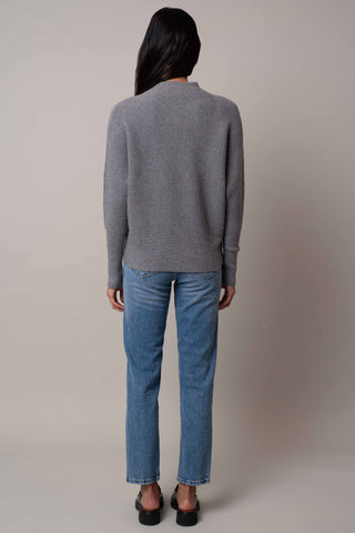 Model is wearing the funnel-neck-sweater-with-ribbed-cuff in Medium Heather Grey