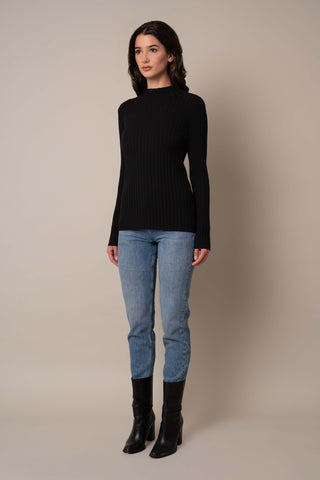 Model is wearing the Mock Neck Ribbed Pullover in Black.