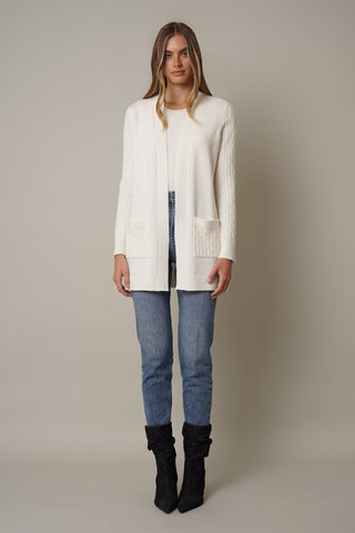 model is wearing the Cable Knit Cardigan with Pockets by cyrus in cream