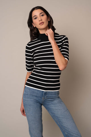 Model is wearing the Mock Neck Striped Pullover in Black/Cream.