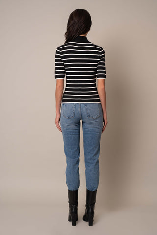 Model is wearing the Mock Neck Striped Pullover in Black/Cream.