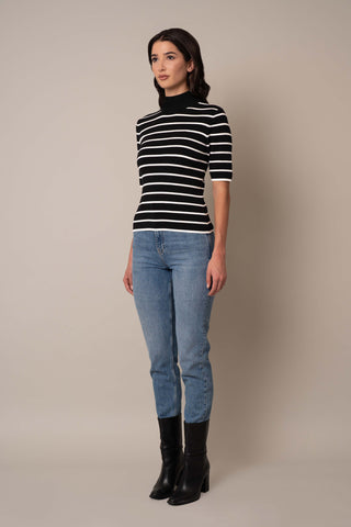 Model is wearing the Mock Neck Striped Pullover in Black/Cream.