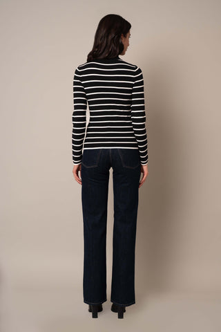 Model is wearing the Long Sleeve Mock Neck Striped Pullover in Black/Cream.