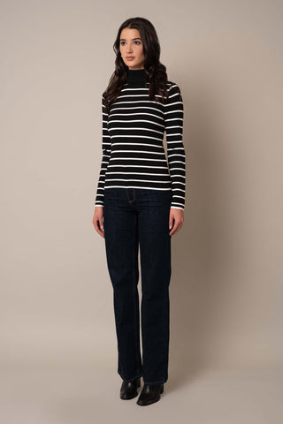 Model is wearing the Long Sleeve Mock Neck Striped Pullover in Black/Cream.