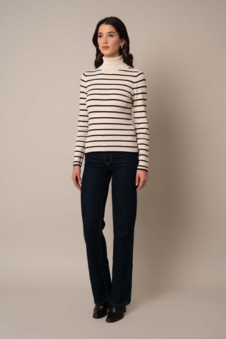 Model is wearing the Long Sleeve Mock Neck Striped Pullover in Sand Heather/Black.