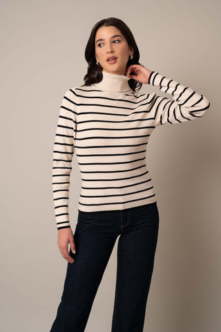 Model is wearing the Long Sleeve Mock Neck Striped Pullover in Sand Heather/Black.