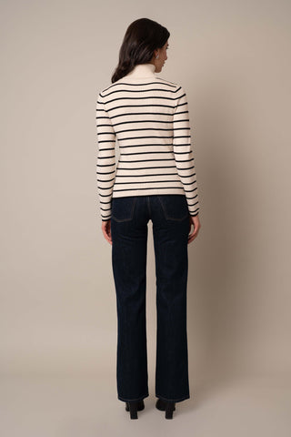 Model is wearing the Long Sleeve Mock Neck Striped Pullover in Sand Heather/Black.