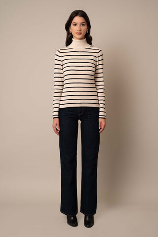 Model is wearing the Long Sleeve Mock Neck Striped Pullover in Sand Heather/Black.