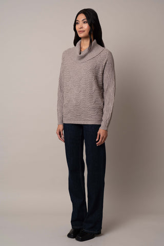 Model is wearing the cable-knit-cowl-neck-sweater in Cinder