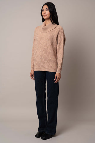 Model is wearing the cable-knit-cowl-neck-sweater in Toffee