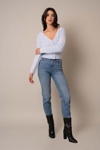 Model is wearing the V-Neck Mink Cardigan in Delicate Blue.