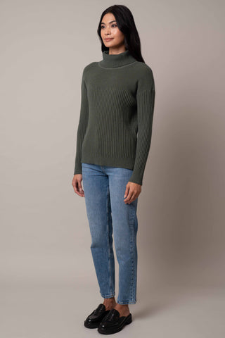 Model is wearing the wide-turtle-neck-pullover in Forest Heather