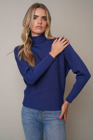 Model is wearing the Funnel Neck Long Sleeve Sweaterby Cyrus in Capnord