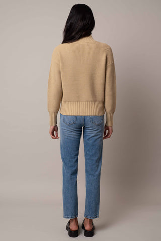 Model is wearing the waffle-mock-neck-pullover in Pale Olive