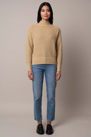 Model is wearing the waffle-mock-neck-pullover in Pale Olive