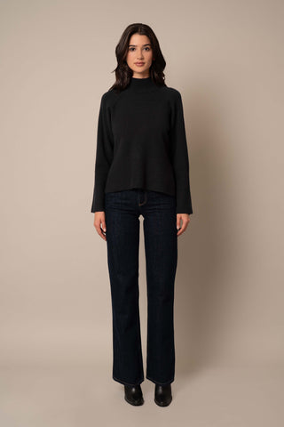 Model is wearing the Relaxed Mock Neck Sweater in Black.