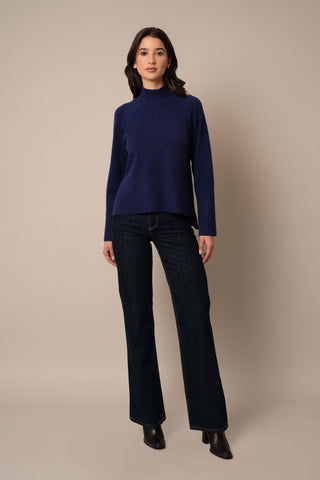 Model is wearing the Relaxed Mock Neck Sweater in Eclipse.