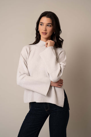 Model is wearing the Relaxed Mock Neck Sweater in Grey Goose Heather.