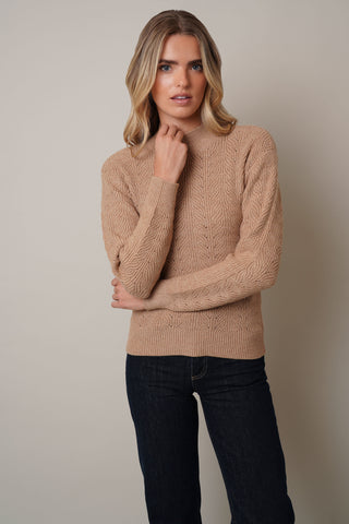 Model is wearing the Textured Mock Neck Sweaterby Cyrus in Toffee