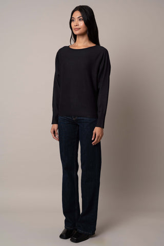 Model is wearing the long-sleeve-dolman-sweater in Black