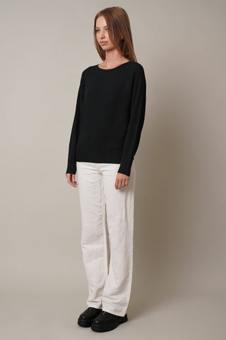 Model is wearing the dolman-boat-neck-sweater in Black