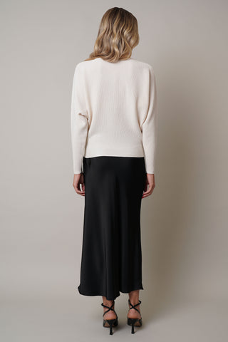 Model is wearing the dolman-boat-neck-sweater in Cream