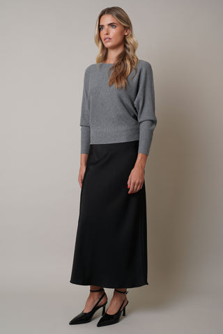 Model is wearing the dolman-boat-neck-sweater in Medium Heather Grey