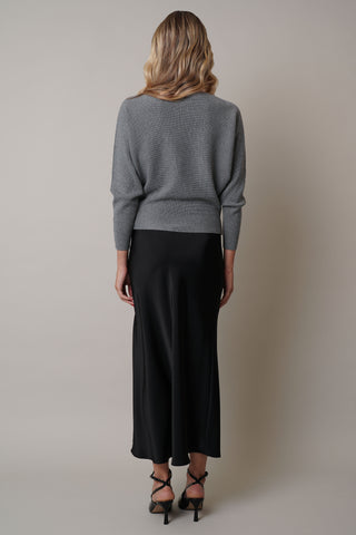 Model is wearing the dolman-boat-neck-sweater in Medium Heather Grey