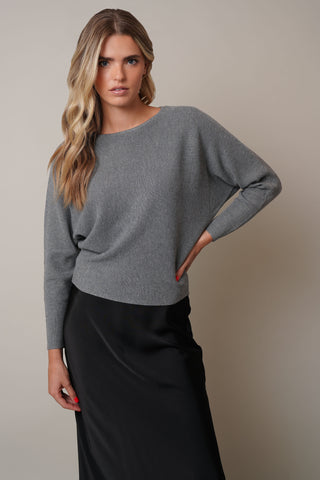 Model is wearing the dolman-boat-neck-sweater in Medium Heather Grey