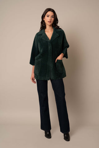 Model is wearing the 3/4 Sleeve Mink Coat in Scarab Green.