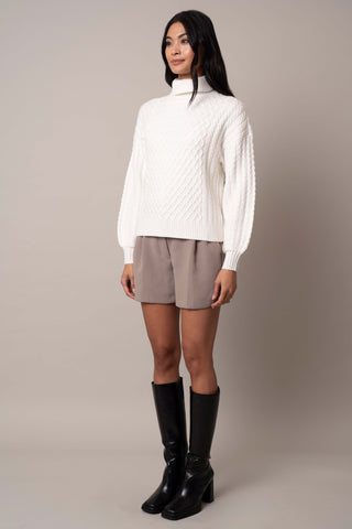 Model is wearing the balloon-sleeve-turtle-neck-sweater in Bone