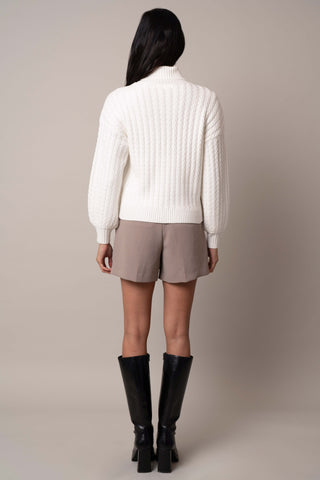 Model is wearing the balloon-sleeve-turtle-neck-sweater in Bone