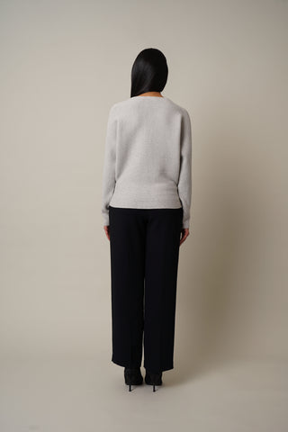 Model is wearing the Boat Neck Sweater in Light Heather Grey.