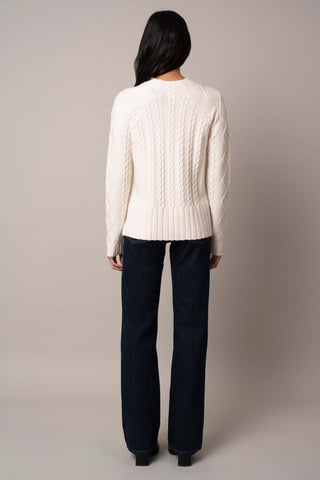 Model is wearing the cable-funnel-neck-pullover in Cream