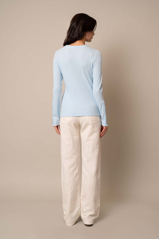 Model is wearing the Waffle Long Sleeve Crew Neck Top in Delicate Blue.