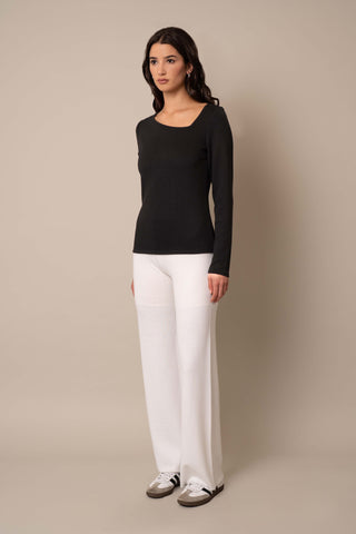 Model is wearing the Asymmetric Neck Top in Black.