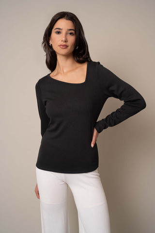 Model is wearing the Asymmetric Neck Top in Black.