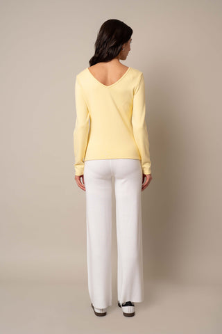 Model is wearing the Long Sleeve V-Neck Top in French Vanilla.