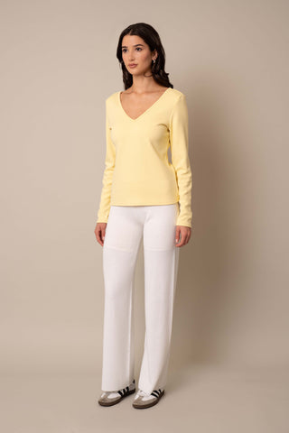 Model is wearing the Long Sleeve V-Neck Top in French Vanilla.