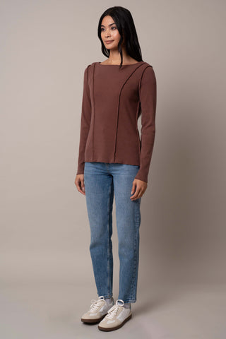 Model is wearing the Long Sleeve Boat Neck Shirt in Clay.