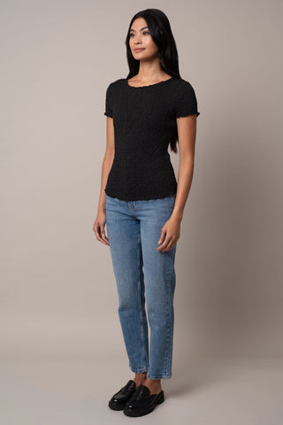 Model is wearing the Short Sleeve Crinkle Top in Black.