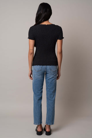 Model is wearing the Short Sleeve Crinkle Top in Black.